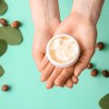 Woman holding jar of shea butter